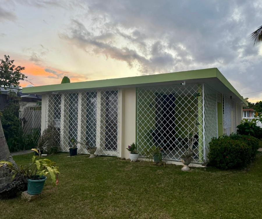 Residencia con pintura exterior terminada, tonos crema y acento verde